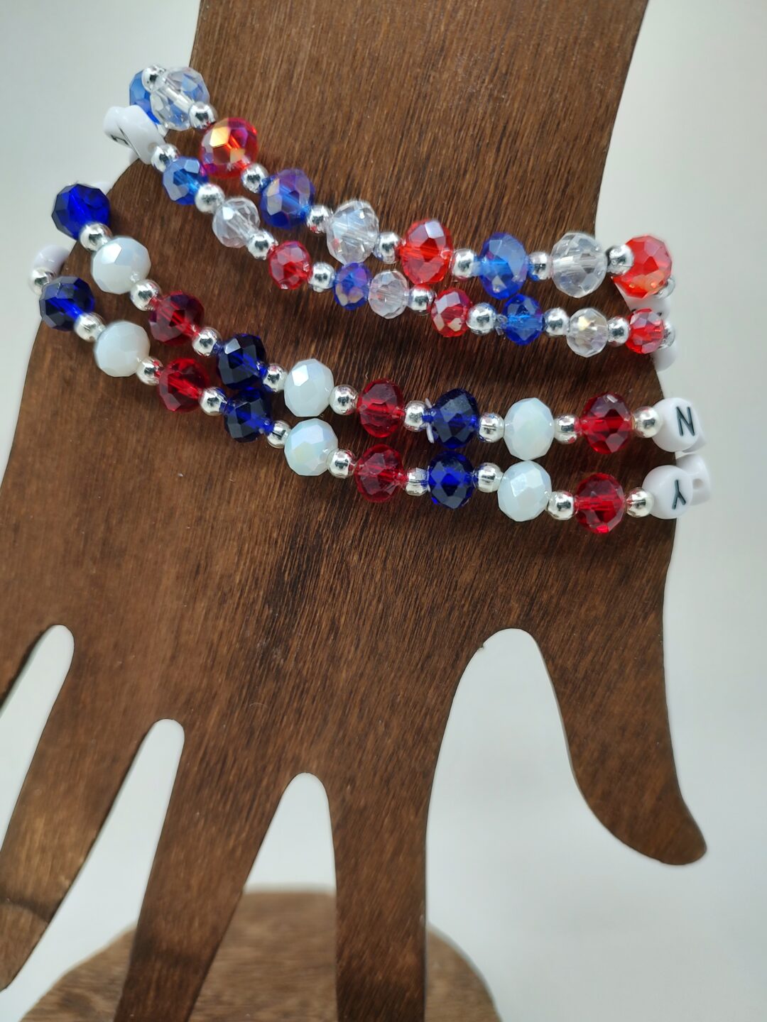 IMG 20240523 160007646 HDR scaled <ul> <li><strong>Stand out with patriotic pride</strong>: Show off your love for the USA with our Custom Snap Crackle Pop Bracelet featuring vibrant red, white, and blue crystal beads. Perfect for celebrating holidays or adding a pop of color to any outfit, this handcrafted bracelet is a stylish symbol of American spirit.</li> <li><strong>Handcrafted precision</strong>: Each cord is meticulously crafted with 4x7mm Acrylic Letter Beads and shimmering crystal beads, creating a unique and eye-catching accessory that is sure to elevate your style. The combination of iron spacer beads adds an extra touch of elegance to these stretch bracelets.</li> <li><strong>Exclusive design</strong>: Make a bold statement with our exclusive Snap Crackle Pop Bracelet, designed to showcase your patriotism in a fashionable way. Whether you choose silver or gold spacer beads, this string bracelet exudes sophistication and charm.</li> <li><strong>Effortless style upgrade</strong>: Elevate your look effortlessly with these bracelets for women that are not just accessories but expressions of pride and individuality. The stretch design ensures a comfortable fit for all wrist sizes, making it easy to wear and pair with any ensemble.</li> <li><strong>Versatile fashion accessory</strong>: From casual outings to special occasions, these custom bracelets are versatile enough to complement a wide range of outfits. Add a touch of sparkle and personality to your wardrobe while proudly displaying your love for the USA.</li> </ul>